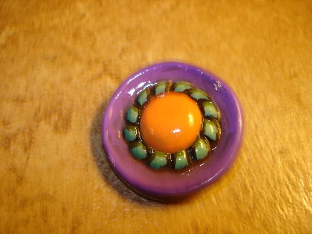 Large nicely painted plastic button.