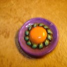 Large nicely painted plastic button.
