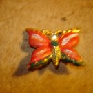 Large colorful metal button in shape of butterfly Large colorful metal button in shape of butterfly