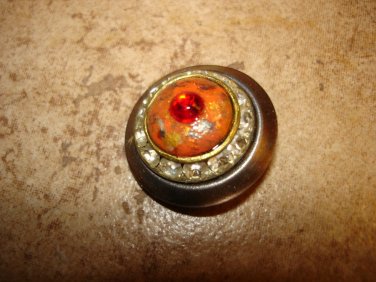Large vintage metal button with white and red rhinestones.