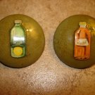 Set of 2 large old celuloid buttons with orange and citrus lemonade. Set of 2 large old celuloid buttons with orange and citrus lemonade.