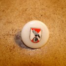 Mother of pearl button with bird and globe.
