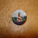 Nicely painted button with lighhouse.