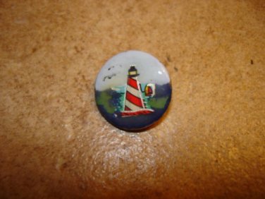 Nicely painted button with lighhouse.