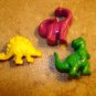 Lot of 3 plastic realistic dinosaurs buttons.