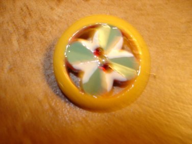 Nicely painted plastic button with tiny rhinestones.