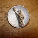Old metal button with Statue of Liberty.