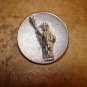 Old metal button with Statue of Liberty.