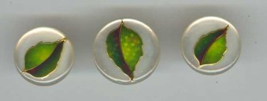 Set of 3 plastic buttons with green leaf.