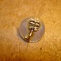 Mother of pearl button with silver key.