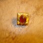 Vintage gold metal button with glass bead.