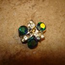 Delicate silver metal button with green rhinestones. Delicate silver metal button with green rhinestones.