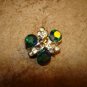 Delicate silver metal button with green rhinestones.