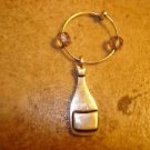 Silver metal bottle with glass beads and ring key chain. Silver metal bottle with glass beads and ring key chain.