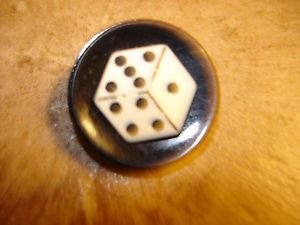 Black plastic button with dice.