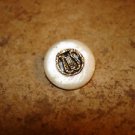 Vintage mother of pearl button with carved in inlay harp.