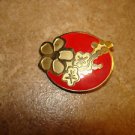Large gold metal button with red & gold flower.