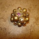 Mother of pearl button with gold color beads.