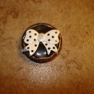 Large gold metal button with large bow. Large gold metal button with large bow.