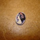 Oval plastic button with Roman lady bust.