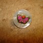 Mother of pearl button with butterfly and tiny red rhinestone.