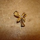 Gold metal ribbon button with bell and rhinestone.