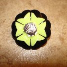 Black carved plastic button with metal sea shell. Black carved plastic button with metal sea shell.