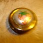 Gold metal button with strawberry.