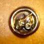 Gold metal button with roller skates.