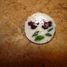 Signed silver metal button with purple flower. Signed silver metal button with purple flower.