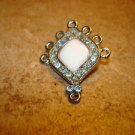 Silver metal button with pearl and blue rhinestones. Silver metal button with pearl and blue rhinestones.