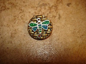 Gold metal button with dragonfly.
