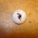 Mother of pearl button with black devil.