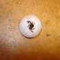 Mother of pearl button with black devil.