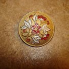 Gold metal button with red flowers and ivy. Gold metal button with red flowers and ivy.