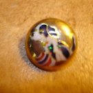 Dome shape gold metal button with dog and ball.
