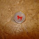 Small mother of pearl button with red lion.