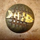 Large carved hard plastic button with gold metal fish skeleton. Large carved hard plastic button with gold metal fish skeleton.