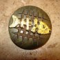 Large carved hard plastic button with gold metal fish skeleton.