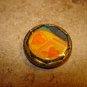 Gold metal button with hearts.