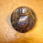 Old mother of pearl button with cash register.
