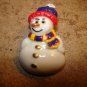 Cute snowman button with hat and scarf.