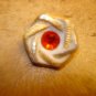 Nicely carved plastic button with red rhinestone.