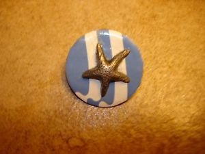 Metal button with ocean star.