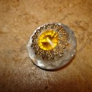 Large glass like button with large yellow rhinestone. Large glass like button with large yellow rhinestone.