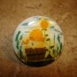 Large plastic button with picture like mushroom & floral garden.