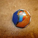 Medium plastic button with colorful bird.