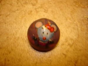 Old dome shape metal button with funny mouse.
