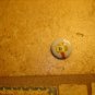 Old metal button with mail box and bird.