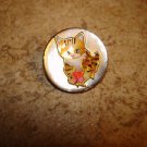 Mother of pearl button with orange cat holding a fish. Mother of pearl button with orange cat holding a fish.